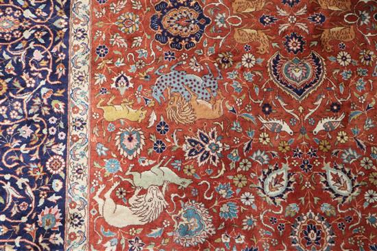 An Indian red and blue ground carpet 319 x 153cm